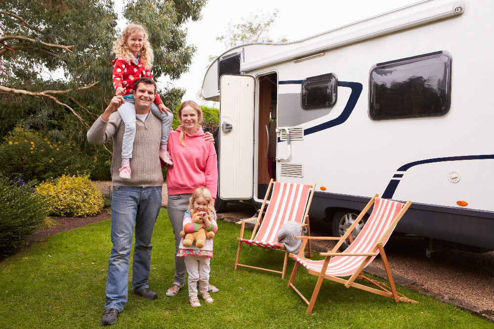 Family standing outside of their RV.